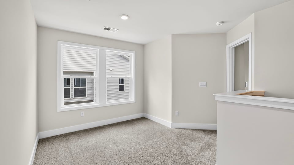 Loft area with carpet.