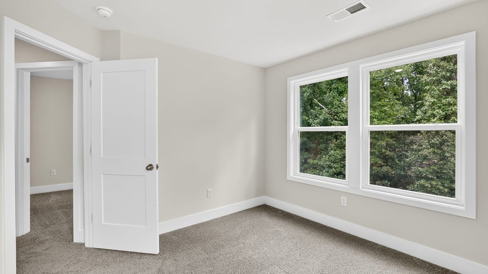 Bedroom with carpet and window.