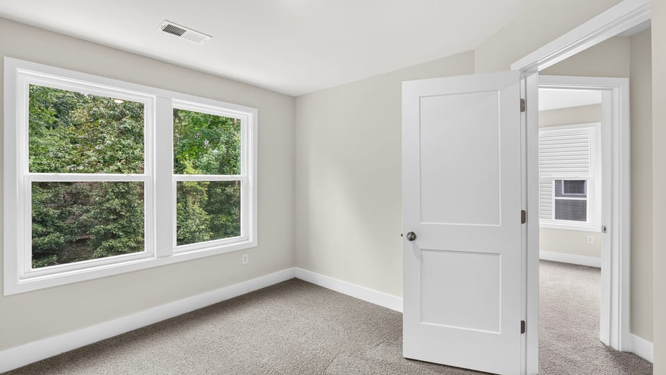 Bedroom with carpet and window.