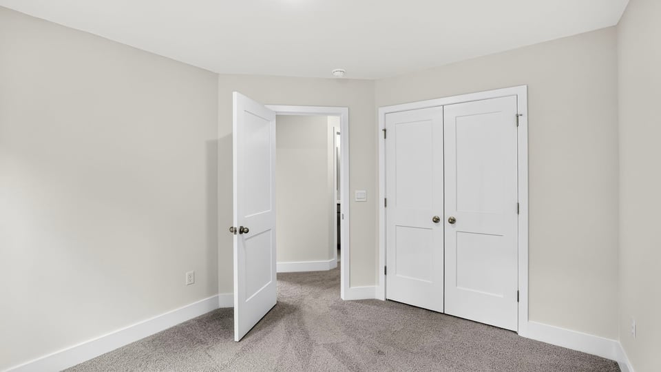 Bedroom with carpet and window.