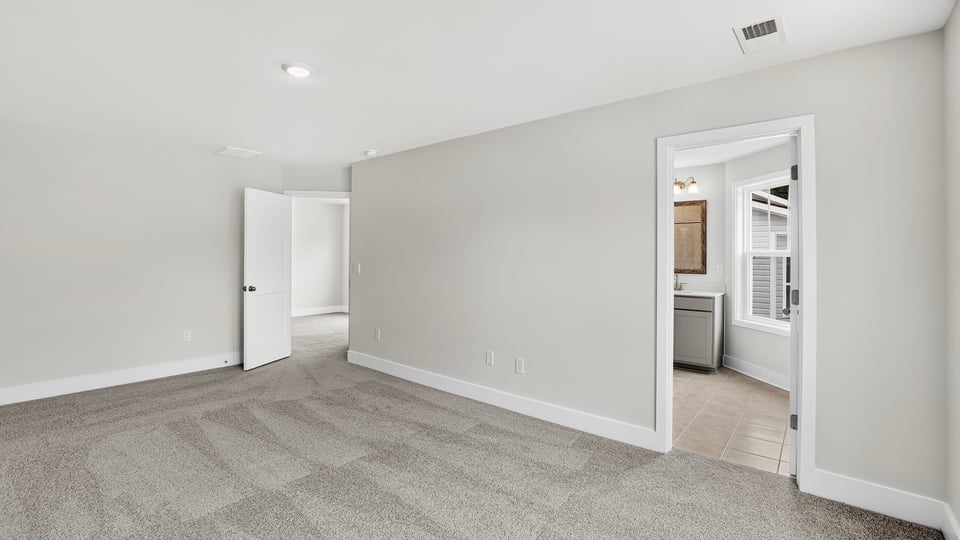 Bedroom with carpet and window.