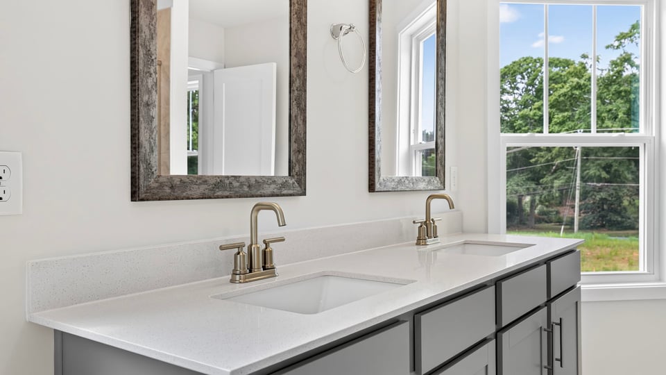 Bathroom with double vanity sink and window.