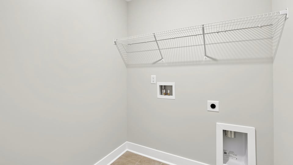 Laundry room with hanging storage racks.