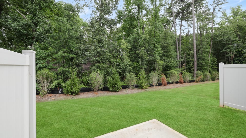 Back exterior of home with yard.