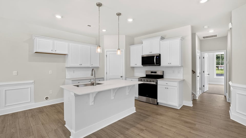 Kitchen and island with quartz counterops.