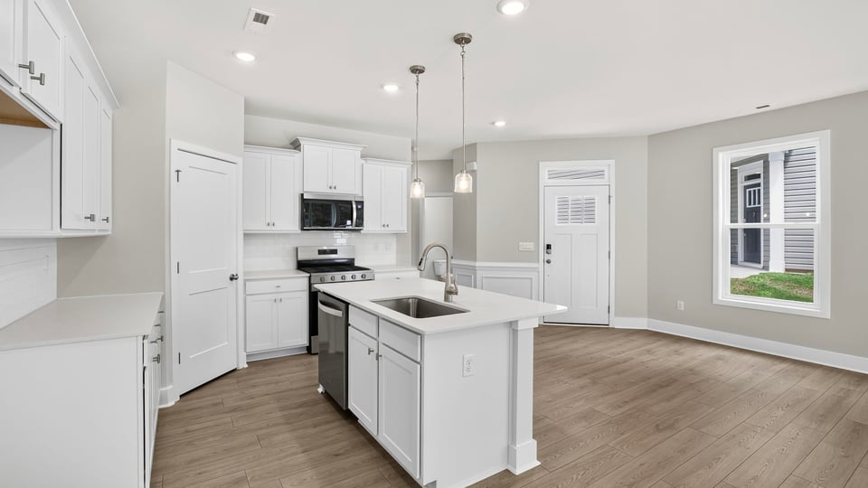 Kitchen and island with quartz counterops.