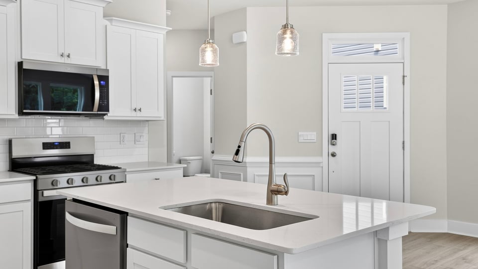 Kitchen and island with quartz counterops.