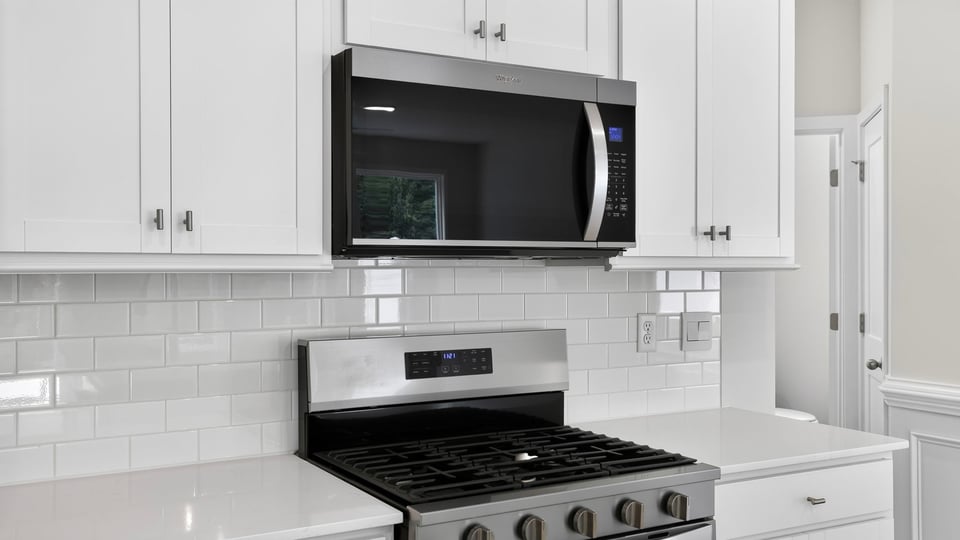 Kitchen and island with quartz counterops.