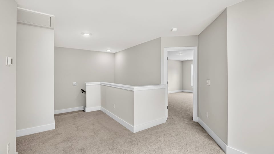 Loft area with carpet.