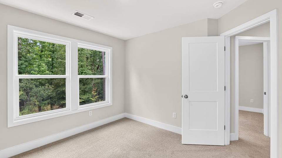 Bedroom with carpet and window.