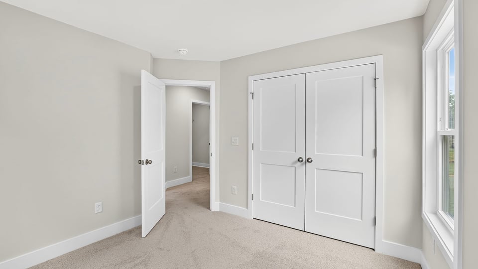 Bedroom with carpet and window.