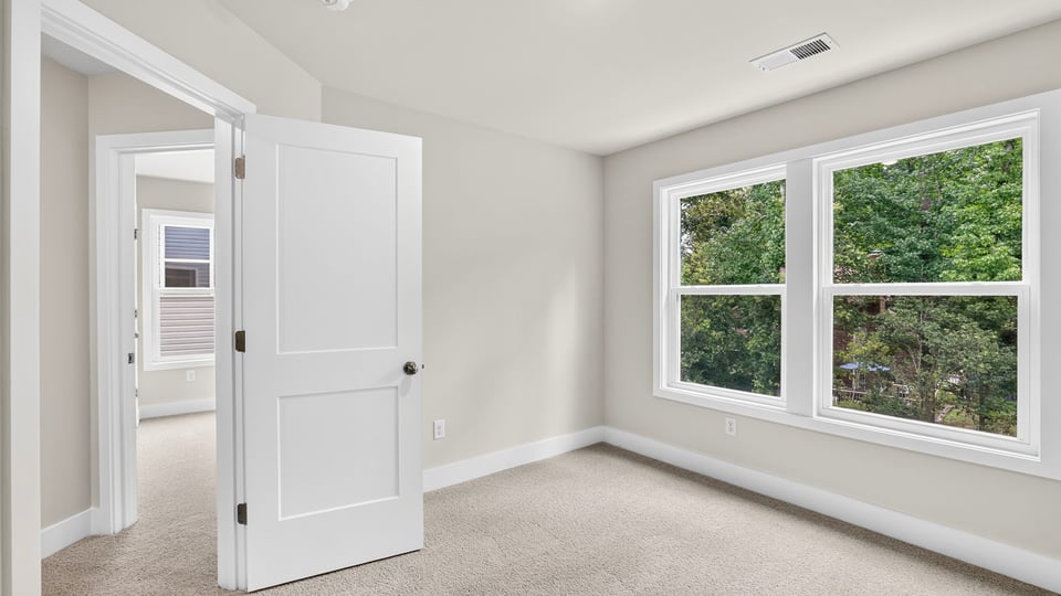 Bedroom with carpet and window.