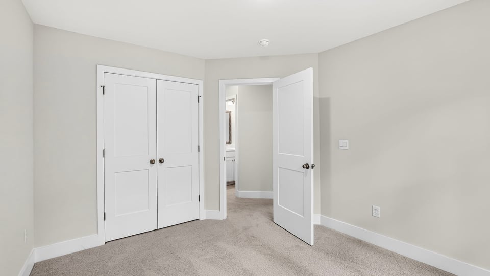 Bedroom with carpet and window.