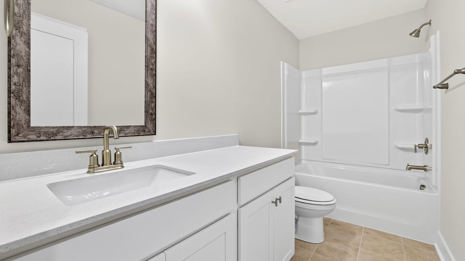 Bathroom with double vanity sink and bathtub.