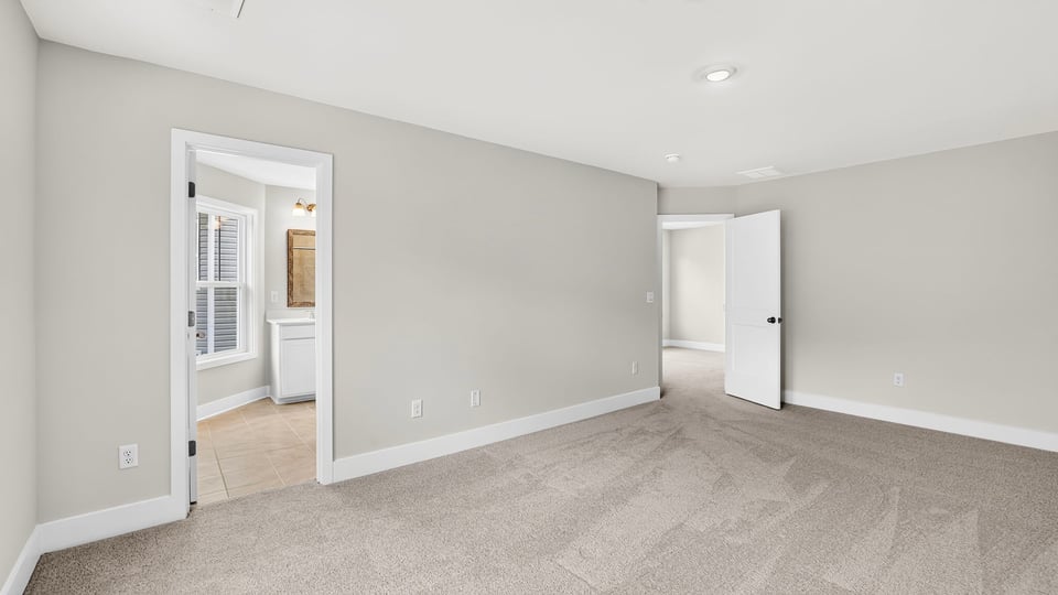 Bedroom with carpet and window.