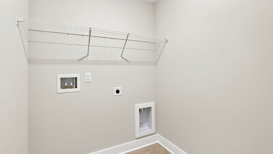 Laundry room with hanging storage racks.