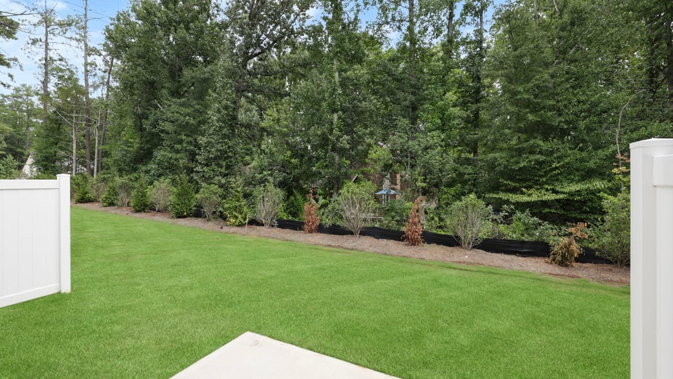 Back exterior of home with yard.