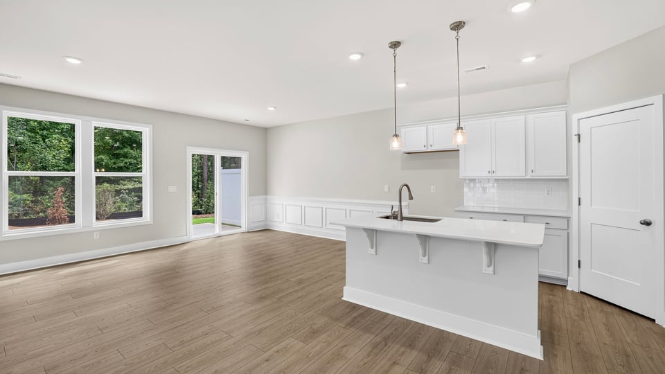 Kitchen and island with quartz countertops.