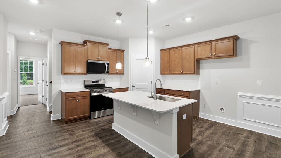 Kitchen and island with quartz countertops.