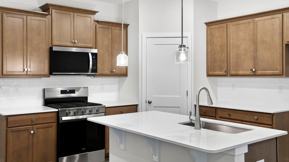 Kitchen and island with quartz countertops.