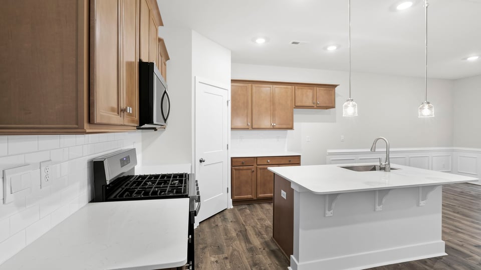 Kitchen and island with quartz countertops.