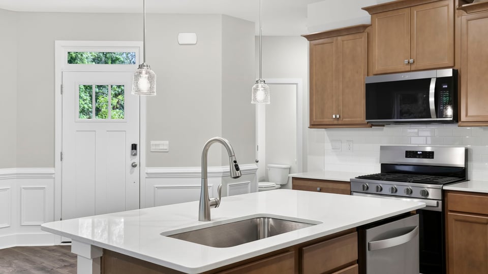 Kitchen and island with quartz countertops.