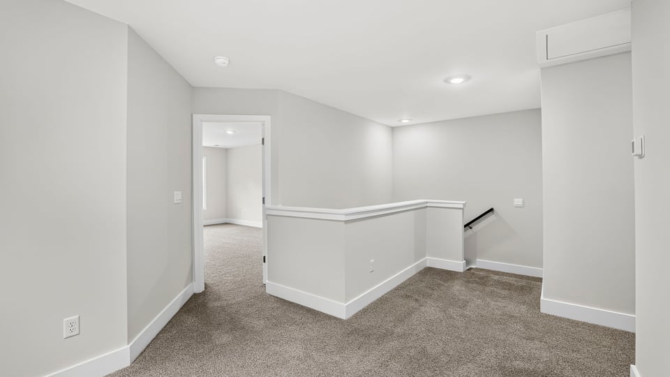 Loft area with carpet and window.