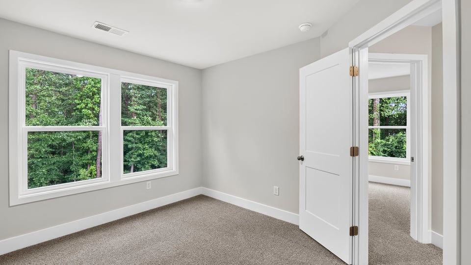 Bedroom with carpet and window.