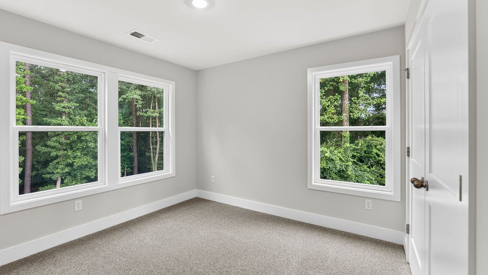 Bedroom with carpet and window.