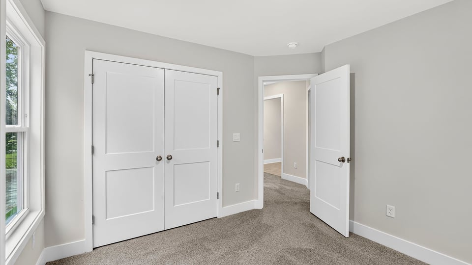 Bedroom with carpet and window.