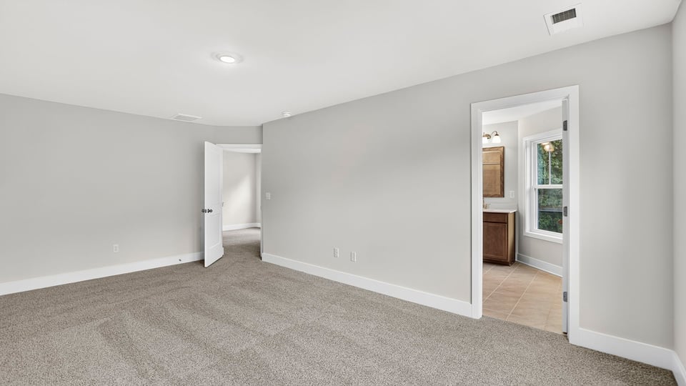 Bedroom with carpet and window.