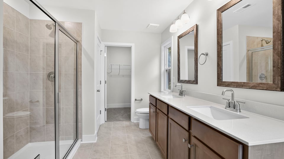 Bathroom with walk in shower and double vanity sink.