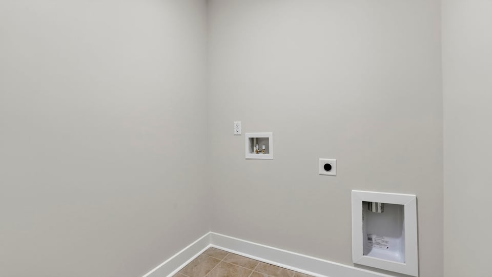 Laundry room with hanging storage racks.