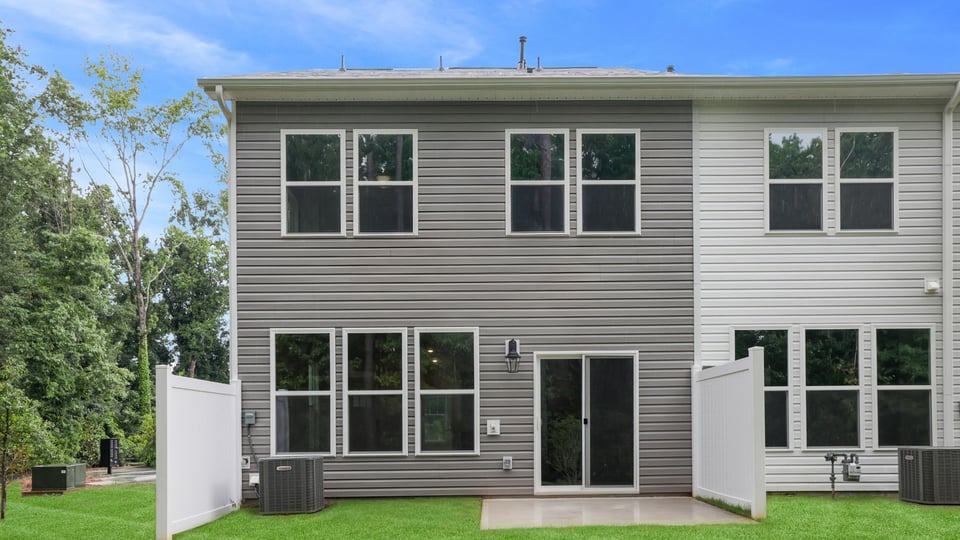 Back exterior of home with yard.