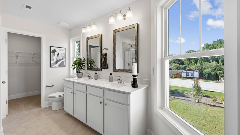 Bathroom with large window and vanity.
