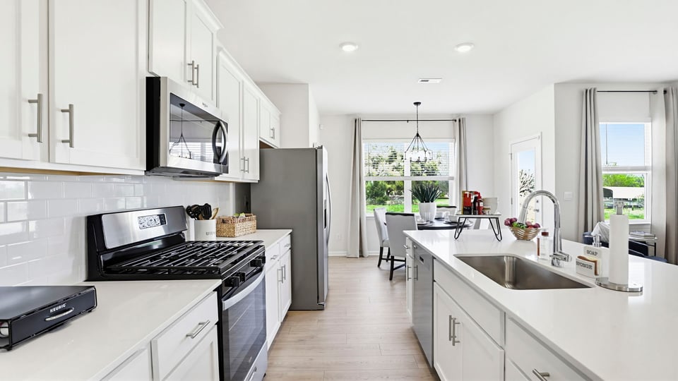 Kitchen with island and cabinets.