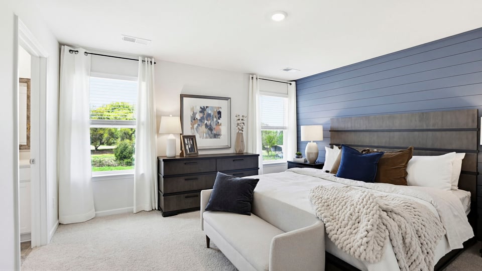 Bedroom with carpet and windows.