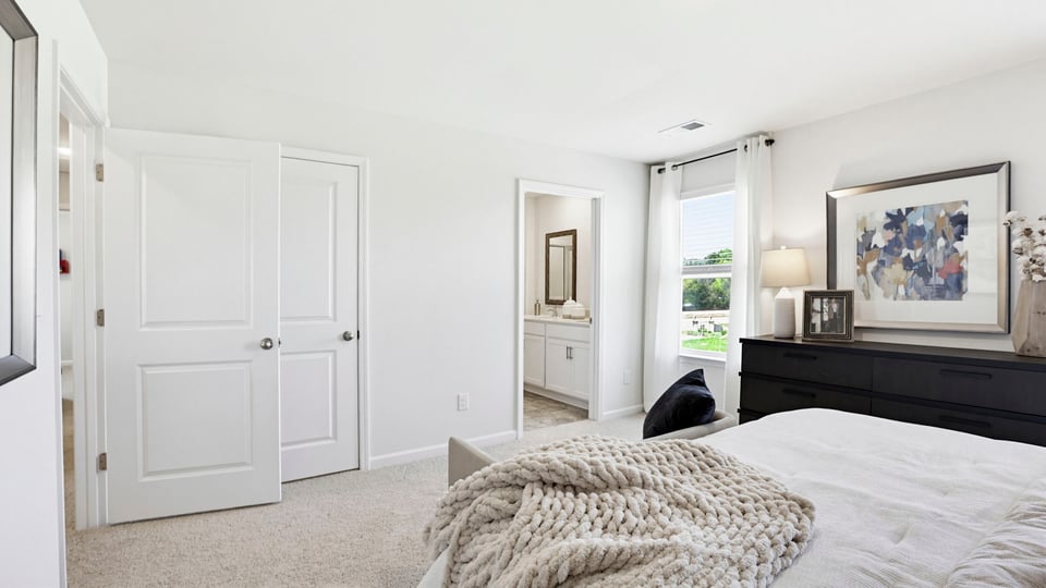 Bedroom with carpet and windows.