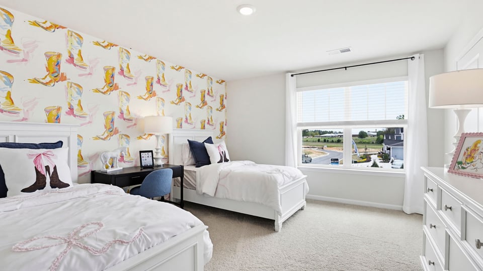 Bedroom with carpet and windows.