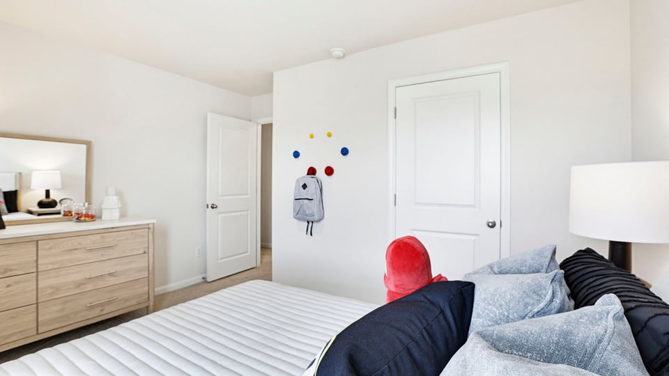 Bedroom with carpet and windows.