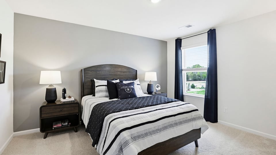 Bedroom with carpet and windows.