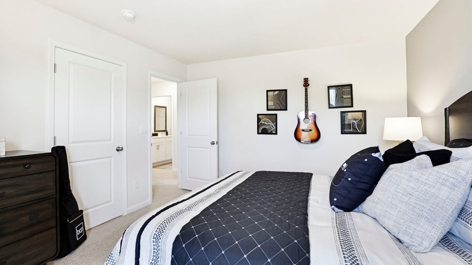 Bedroom with carpet and windows.