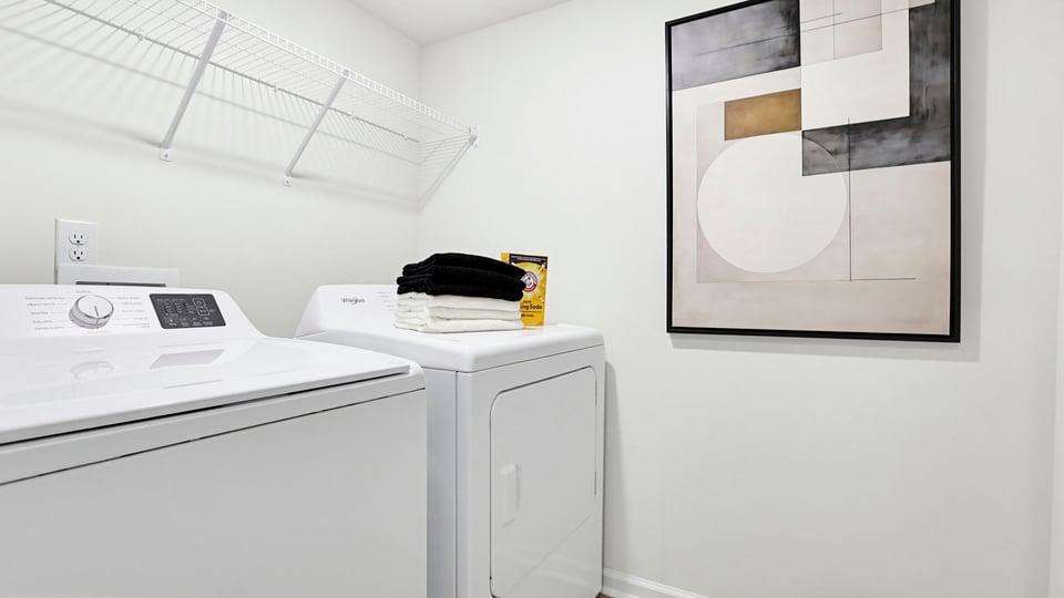 Laundry room with shelf.