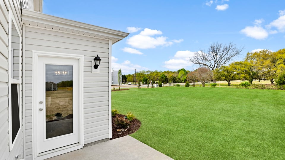 Back exterior with large backyard.