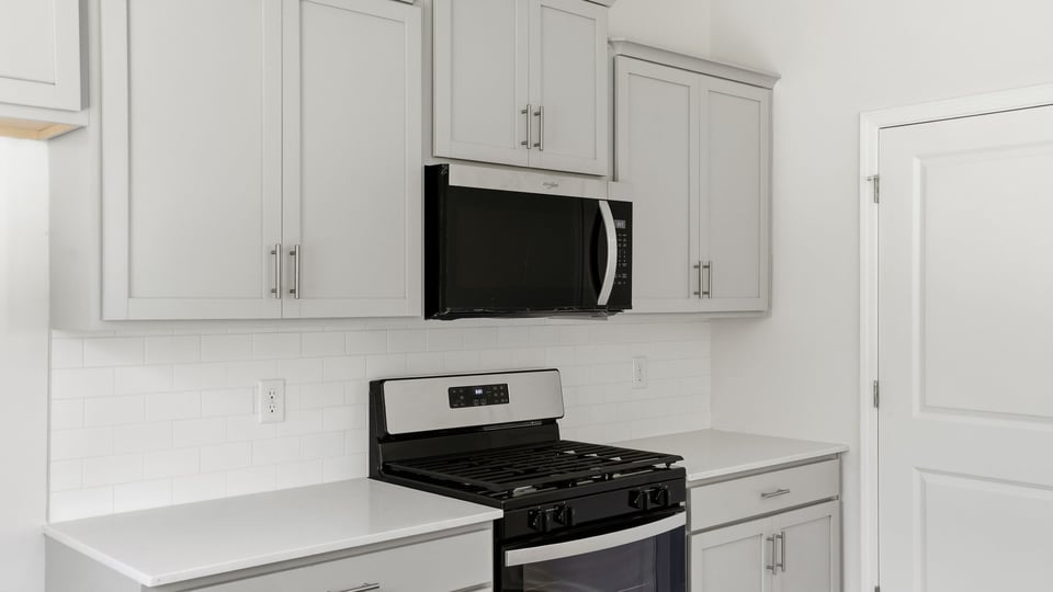 Kitchen and island with quartz countertops.