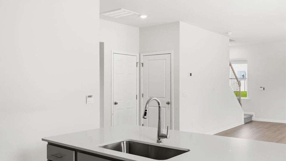 Kitchen and island with quartz countertops.