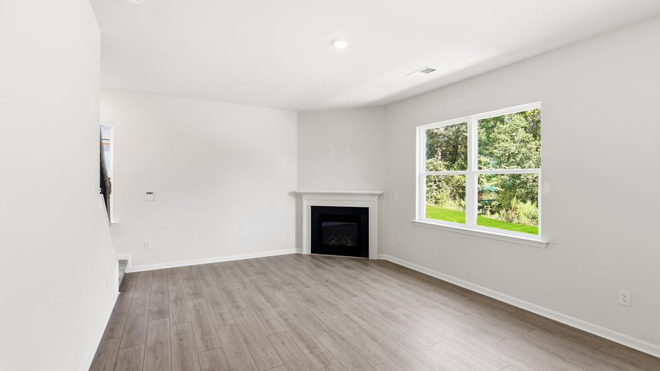 Living room with windows and fireplace.