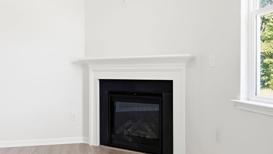 Living room with windows and fireplace.