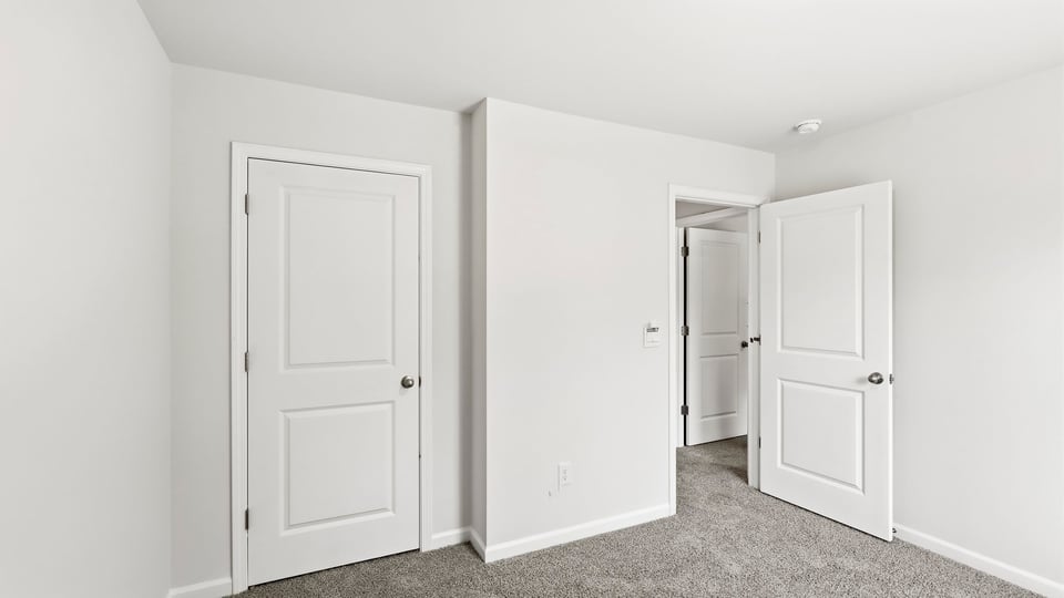 Bedroom with carpet and window.