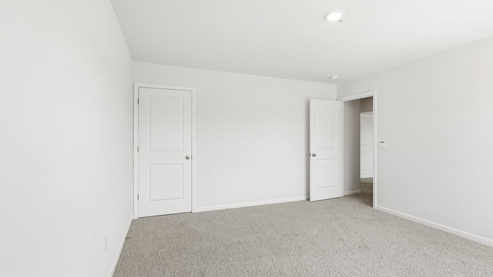 Bedroom with carpet and window.